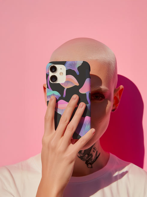 Aesthetic phone case featuring pastel neon mushrooms on a black background. The botanical-inspired design is available for iPhone, Samsung, and Google Pixel models. Glossy or matte finish options with durable, dual-layer protection.